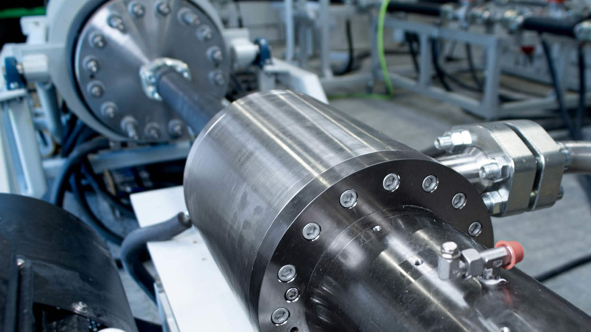 Closeup of geothermal tool component undergoing testing in a technical facility setup.
