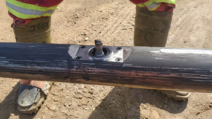 Close-up of a casing section in a SAGD steam injection well showing a precise punch hole made by the Welltec Slim Puncher during a successful intervention in Canada.
