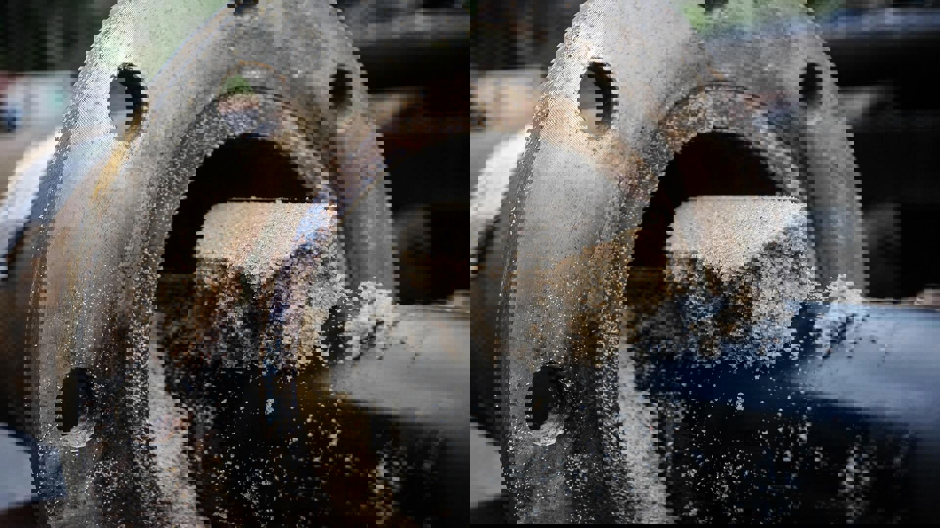 Close-up of a pipe with sand buildup inside, illustrating the restoration of downhole access in an oil or gas well.