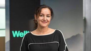 Lia Khasanova, Commercial Director for New Energy & Climate Technology, standing in front of a Welltec display.